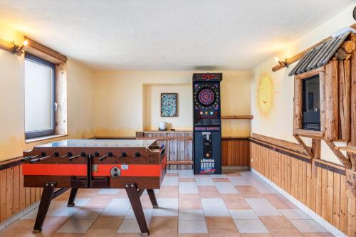 a room with a pool table in the middle of it at Pension Heidelberg in Hopfgarten im Brixental