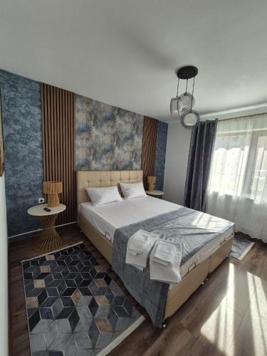 a bedroom with a large bed in a room at Apartament Stefania Targu Ocna in Târgu Ocna