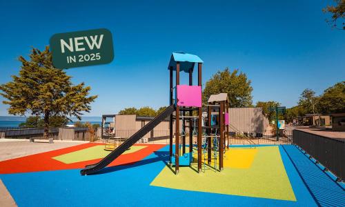 a playground with a slide in a park at Aminess Style Glamping Villas & Holiday Homes Atea in Njivice