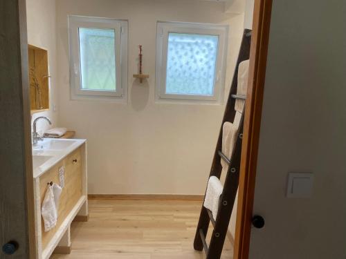 a bathroom with a sink and a window at La belle campagne in Granges-dʼAns