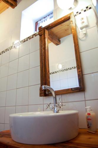 a bathroom with a sink and a mirror at Vitamin B63 Vendégház in Boldogkőváralja