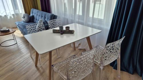 a white table with chairs and a blue couch at Hotel Plzeň in Plzeň