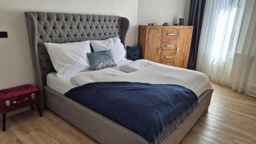 a bedroom with a large bed with a blue blanket at Hotel Plzeň in Plzeň