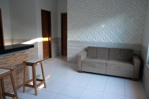 a living room with a couch and a table at Casa amarela in Barreirinhas