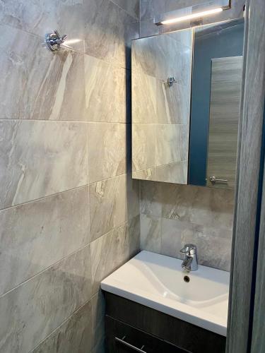 a bathroom with a sink and a mirror at Villa Sangria in Skala Marion