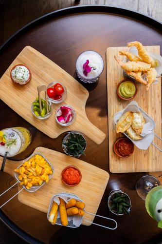 a table topped with wooden cutting boards with different types of food at Courtyard by Marriott Paris Porte de Versailles in Issy-les-Moulineaux
