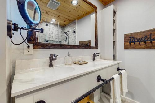 a bathroom with a sink and a mirror at Bee Branch 05 in Sugar Mountain