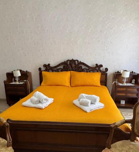 a bedroom with a bed with two towels on it at La CASA DEL SOLE in Paceco
