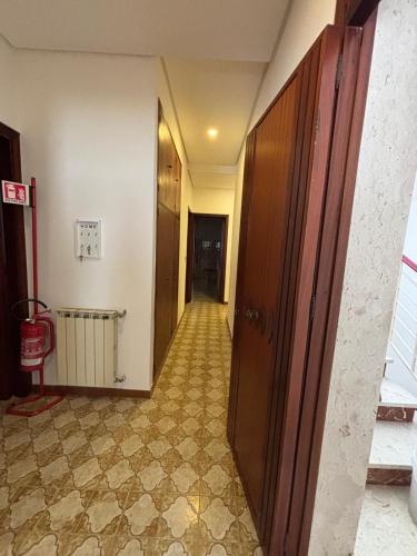 a hallway of a room with a door and a tile floor at La CASA DEL SOLE in Paceco