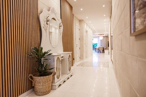 a hallway with a mirror and a potted plant at Villa to rent in Gozo- Iż-Żerriegħa tal-Mustarda in Santu Pietru