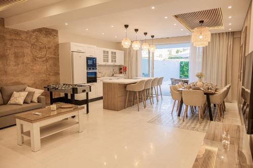 a living room and kitchen with a couch and a table at Villa to rent in Gozo- Iż-Żerriegħa tal-Mustarda in Santu Pietru