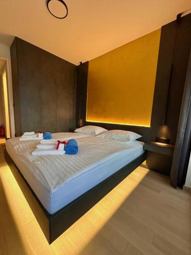a large bed with two stuffed animals on top of it at Boutique Spa Studioapartment IV in Opatija