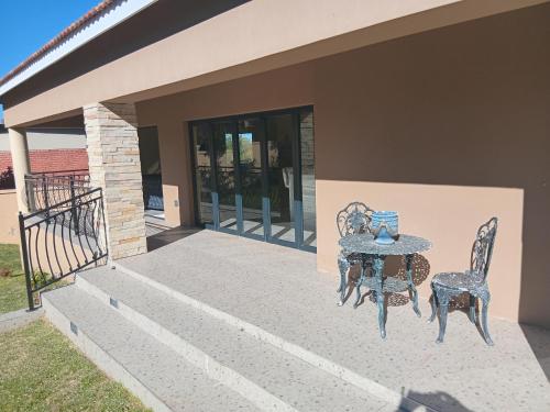 a table and chairs sitting on a patio at Lovemoreheights Inn in Gqeberha