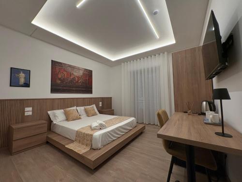 a bedroom with a bed and a desk in it at Domus Matronae in Castellammare di Stabia