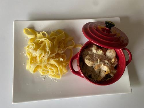 a container of food on a plate with pasta at La belle campagne in Granges-dʼAns