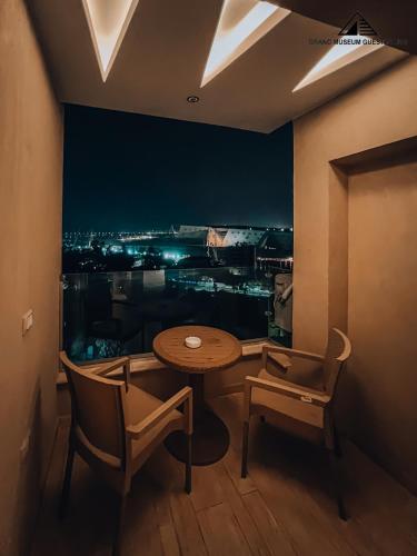 a table and chairs in a room with a view at grand museum view hotel in Cairo