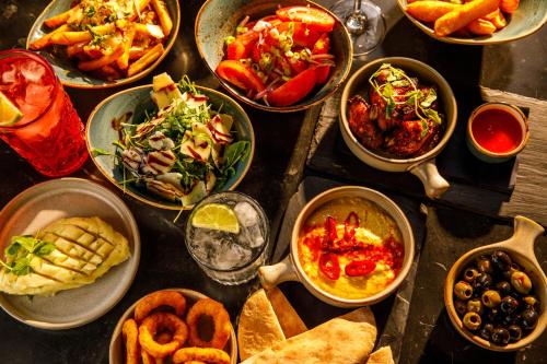 a table with many different dishes of food on it at Novotel London Greenwich in London