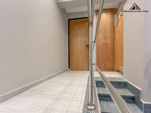a hallway with stairs and a wooden door at grand museum view hotel in Cairo