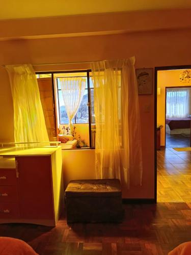 a room with a bed and a window and a desk at Villa Bella Doña Leo in Copacabana
