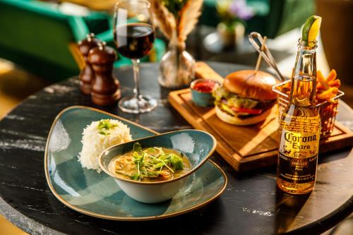 a table topped with a bowl of food and a sandwich at Novotel London Greenwich in London