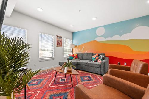 a living room with a couch and a table at Natl Park 2BR Townhome King 2-Car Garage in Salt Lake City