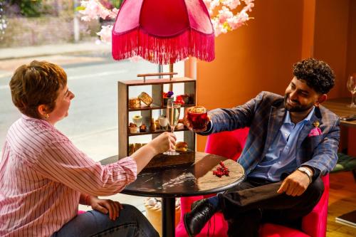 a man and a woman sitting at a table at Novotel London Greenwich in London