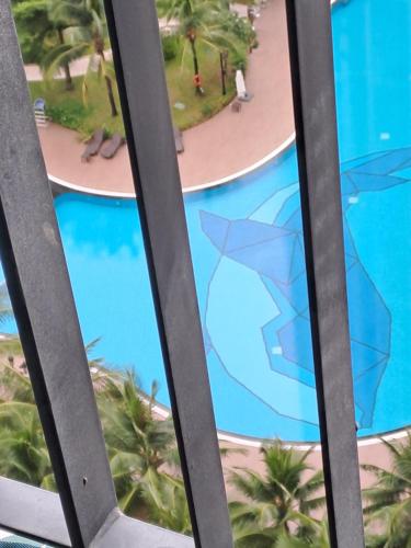 a view of the pool from the window of a resort at Vinhomes grand park Q9 An Trú Homestay in Long Bình