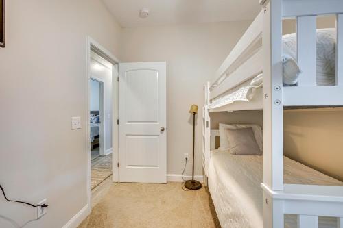 a bedroom with a white bunk bed and a doorway at 1 Mi to Riverfront Darien Family Home in Darien