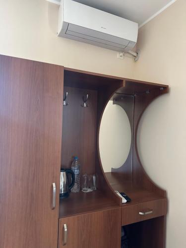 a bathroom with a mirror and a dresser with a sink at Къща за гости Sunrise - Батак in Batak