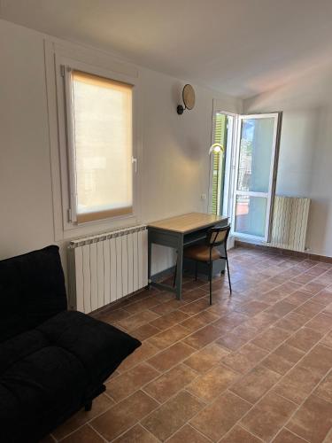 a living room with a table and a couch at Acquasparta Piazza in Acquasparta