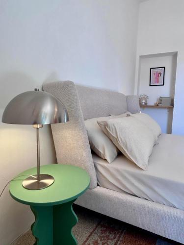 a living room with a couch and a green table at Acquasparta Piazza in Acquasparta
