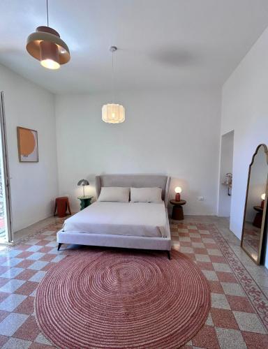 a bedroom with a bed and a large rug at Acquasparta Piazza in Acquasparta