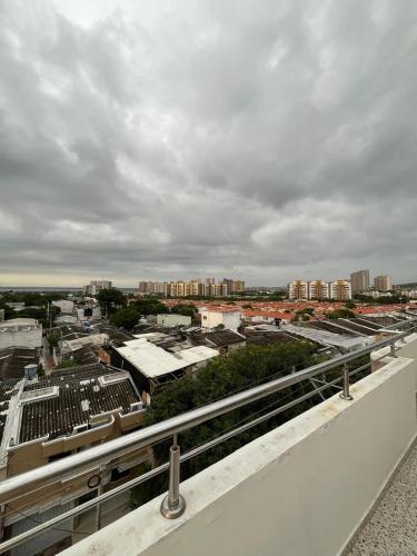 a view of a city with buildings and a cloudy sky at Lindo Apartamento suite country club villas in Santa Rosa
