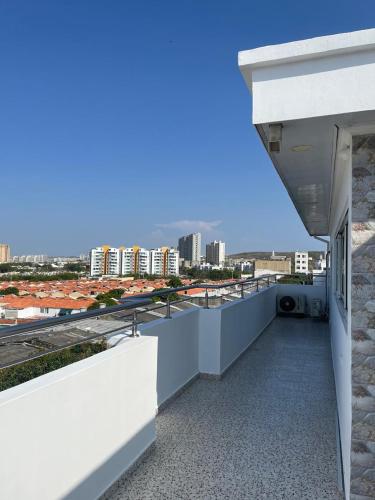 a balcony of a building with a view of a city at Lindo Apartamento suite country club villas in Santa Rosa