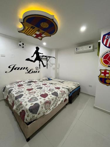 a bedroom with a bed with a soccer ball on the wall at Lindo Apartamento suite country club villas in Santa Rosa