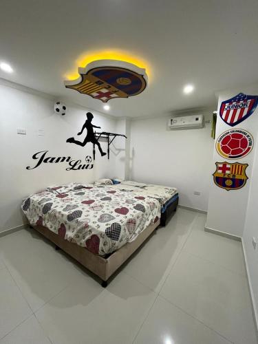 a bedroom with a bed with a soccer ball on the wall at Lindo Apartamento suite country club villas in Santa Rosa