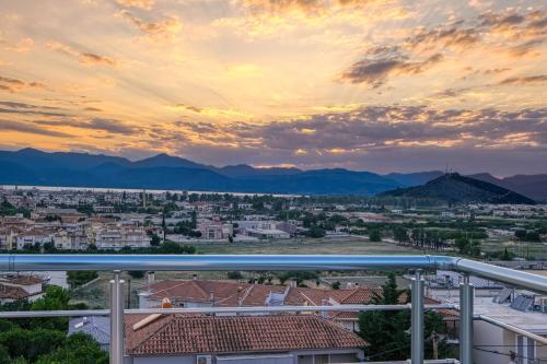 a view of a city at sunset at Faytale Apartment Nafplio in Ária