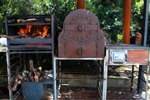 an outdoor grill with a stove and a fire at Casa finca, descanso en medio de la naturaleza . in Tabio