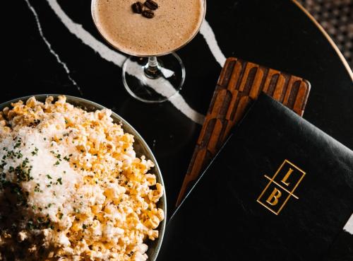 a table with a bowl of popcorn and a drink at Radisson Plaza Hotel at Kalamazoo Center in Kalamazoo
