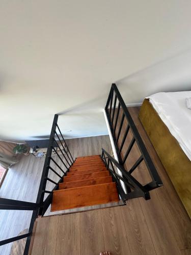a staircase leading to a bedroom with a bed at Bujtinat te Mullari 