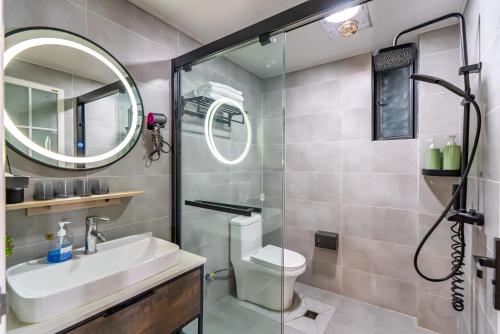 a bathroom with a toilet and a sink and a shower at Misty Nest High Altitude River View B&B Hongyadong Branch in Chongqing