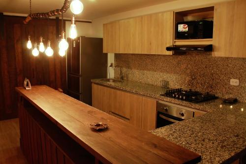 a kitchen with a wooden counter top in a room at Casa finca, descanso en medio de la naturaleza . in Tabio