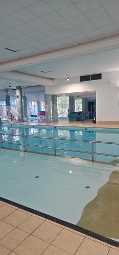 a swimming pool with water in a building at Serenity Nook in Southview Holiday Park in Burgh le Marsh