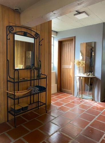 a room with a mirror and a tiled floor at Studio Tamandaré in Garibaldi