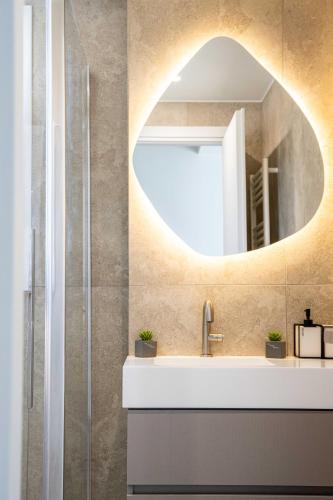 a bathroom with a sink and a mirror at Nireas Blue Balcony by Raise in Áno Váthia