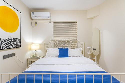 a bedroom with a bed with blue and white sheets at Misty Nest High Altitude River View B&B Hongyadong Branch in Chongqing