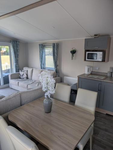 a living room with a table and a couch at Tracey's vans in Skegness
