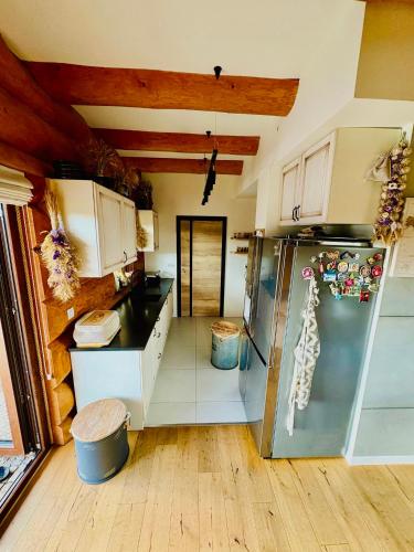 a large kitchen with a refrigerator in a room at chata z widokiem in Grzmiąca