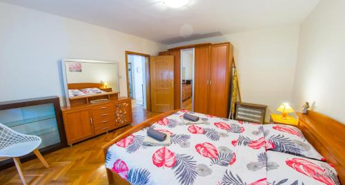 a bedroom with a bed and a dresser and a mirror at Apartment La Vie in Mostar