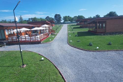a gravel road leading to a building with a restaurant at Turda Retreat in Turda